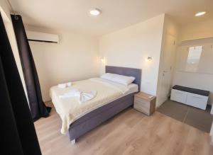 a bedroom with a bed with white towels on it at Villa Luca in Krimovice