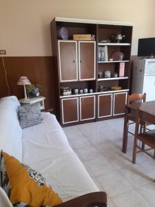 a living room with a white couch and a kitchen at Casa La V G in Almese