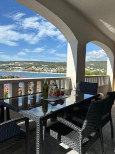 a table and chairs on a balcony with a view of the ocean at Apartman 3 Majba in Zaglavice