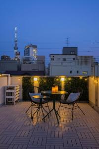 a patio with a table and chairs on a balcony at Skytree View Rooftop Villa Asakusa SVRVA in Tokyo