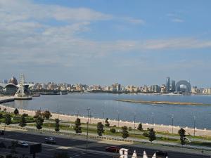 a view of a city with a river and a bridge at Crown Suites in Baku