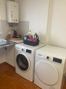 a white washer and dryer in a kitchen at Rolo House in Nazaré +5 photos
