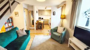 a living room with a couch and a tv at Mews Cottage in Middleton in Teesdale