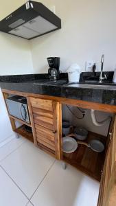 a kitchen with a sink and a counter top at Flats Ana Alves Residence Delta do Parnaíba- Piauí in Parnaíba