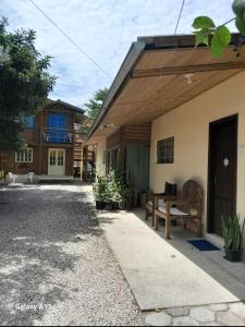 a house with a bench on the side of it at Residencial Álacre casa e cabana aluguel Ferrugem SC in Garopaba