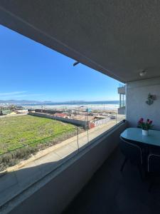 a room with a large window with a view of the beach at Departamento vista al mar in La Serena