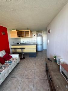 a small room with a kitchen with a bed and a table at Departamento vista al mar in La Serena