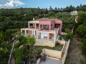 an aerial view of a pink house at Villa Neraida - Panoramic Lake View Retreat in Neráïdha