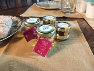 a table topped with jars of food on a table at B&B Palazzo Delogu in Osidda