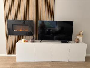 a living room with a tv and a fireplace at Home Terboekt in Genk +31 photos