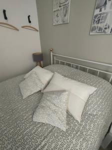 a bedroom with a bed with pillows on it at La Loge du Théâtre in Orange +7 photos
