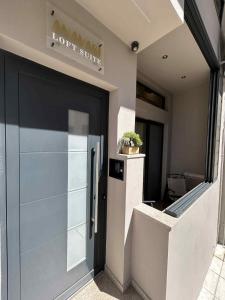 a garage door of a building with a sign on it at ANAVASI Loft SUITE in Alexandroupoli