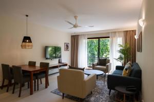 a living room with a table and a dining room at Sea Cliff Court Hotel & Luxury Apartments in Dar es Salaam
