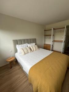 a bedroom with a large bed with a yellow blanket at Casa da Miquinhas in Murça +21 photos