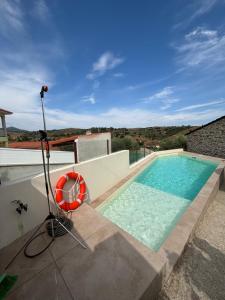 a swimming pool on the roof of a house at Casa da Miquinhas in Murça
