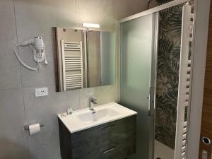 a bathroom with a sink and a mirror at Albergo LA COLDRA in Quarona +24 photos