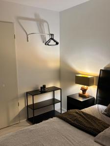 a bedroom with a bed and a lamp on a wall at Gemütliches Zimmer nähe München in Aschheim