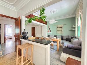 a kitchen and living room with a couch and a table at Rami Home in Casablanca