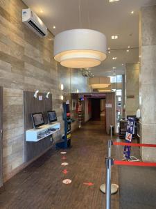 a lobby of an office with a desk and a large light at Flat no Hotel S4 Aguas claras in Brasilia +60 photos