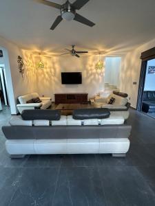 a living room with couches and a flat screen tv at La Kaz'Sica in Saint-André