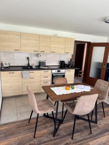 a kitchen with a wooden table and chairs at Cozy apartment in Sankt Goar