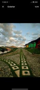 a shadow of a sign on a dirt road at Chalés Novo Horizonte in Natividade do Carangola