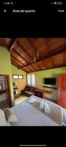 a bedroom with a large bed with towels on it at Chalés Novo Horizonte in Natividade do Carangola