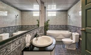 a bathroom with a sink and a tub and a toilet at Cloud Passion Hotel & Apartment in Ho Chi Minh City +42 photos
