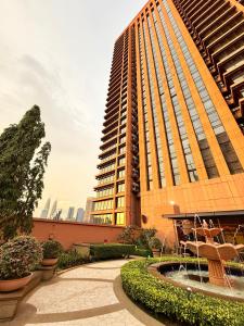 a large building with a fountain in front of it at Elements Service Suites Time Square kl in Kuala Lumpur +87 photos