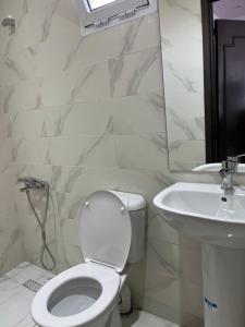 a white bathroom with a toilet and a sink at STUDIO FOR 3 PERSON & ANOTHER FOR 4 PERSON - MIRAMAR MARTIL ll in Martil +33 photos