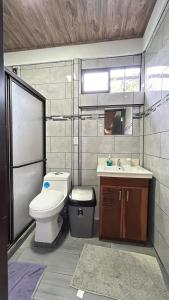 a bathroom with a toilet and a sink at Casa Selva Viva in Uvita +9 photos