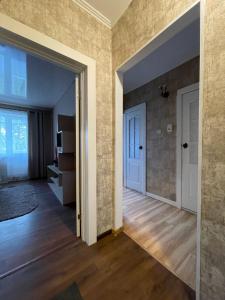 an empty room with a door leading to a living room at Apartamenty. Geroev Krut in Sumy