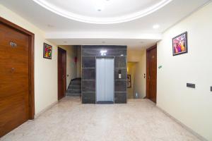 a hallway with a door and stairs in a building at Hotel IBY Near Delhi Airport in New Delhi +18 photos