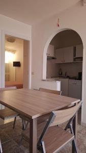 a wooden table in a room with a kitchen at La maison del pescatore in Cetara
