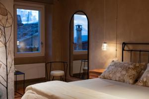 a bedroom with a bed and a view of a lighthouse at Le erbe magiche in Collepardo