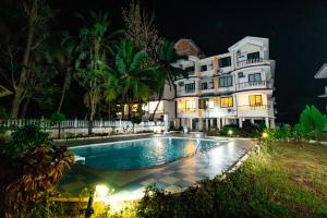 a large house with a swimming pool at night at Casale Majorda in Majorda