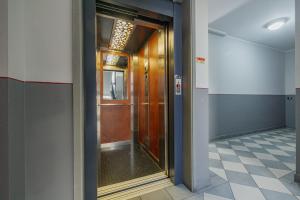 a glass door in a hallway with a tile floor at Harmonia Living - Affitti Brevi Italia in Vigevano +40 photos