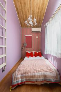 a bedroom with a bed with red pillows at Skytree View Rooftop Villa Asakusa SVRVA in Tokyo +223 photos