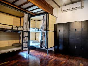 a room with three bunk beds and a closet at Wood Wood Hostel in Vientiane