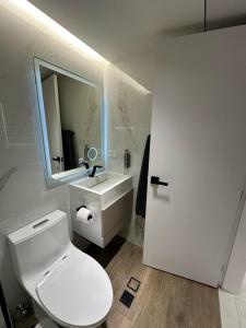 ein Badezimmer mit einer weißen Toilette und einem Waschbecken in der Unterkunft Apartmento Lecheria 3 hab 2 baños Moderno hasta 8 personas in El Morto de Barcelona