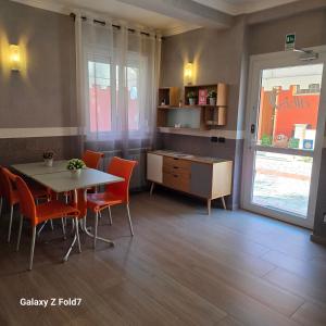 a kitchen and dining room with a table and chairs at Albis Rooms Guest House in Fiumicino