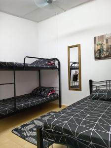 a bedroom with two bunk beds and a mirror at Salza Homestay in Hulu Langat +4 photos