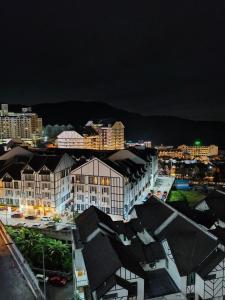 a view of a city at night with buildings at KhaiLa Emerald Apartment Cameron Highlands in Brinchang