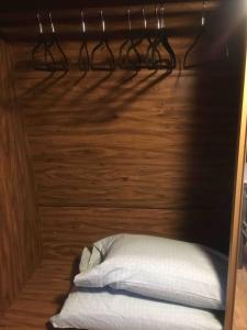 a room with a bed and a wooden wall with glasses at Stargazer, AC, Heat, Free firewood, ice cream, bottled water and smores in Williams