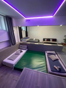 a room with three beds and a pool of water at O5 residence in Nivy
