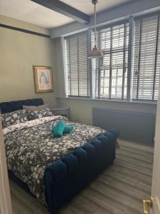 a bedroom with a bed with a blue couch at The workshop in Kings Lynn