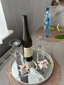 a bottle of wine and two glasses on a table at BaSoTo in Sopot +33 photos