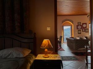 a bedroom with a bed and a lamp on a table at Sophia's Stone House in Dimitsana