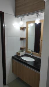 a bathroom with a sink and a mirror at Comfortable and Elegant Apartment, in Santa Cruz de la Sierra +10 photos