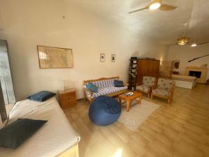 a living room with two beds and a couch at Το σπίτι του Καντήλα in Leonidion